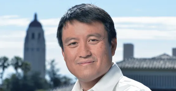 Photo of Dr. Shanhui Fan at Stanford, with Hoover Tower in the background.