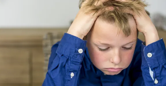Photo of child sighing over homework.