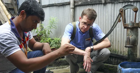 Photo of Dr. Stephen Luby with a teammate in Dhaka, Bangladesh, testing water samples.