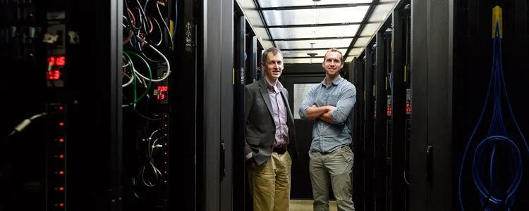 Photo of Evan Reed and Austin Sendek in server room.