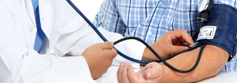 Photo of man getting his blood pressure taken.