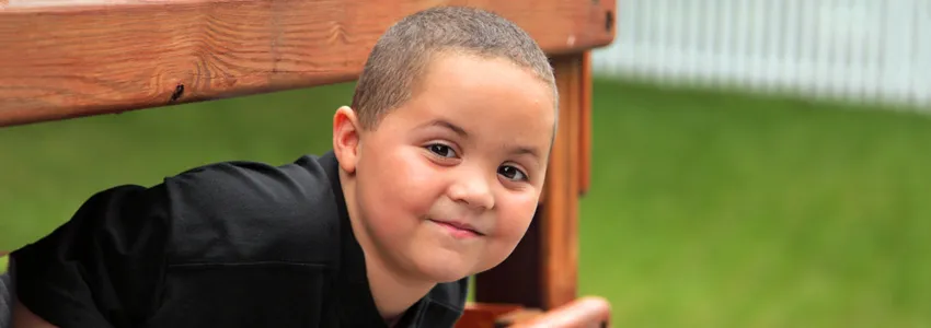 Photo of a young Latino boy playing outdoors.