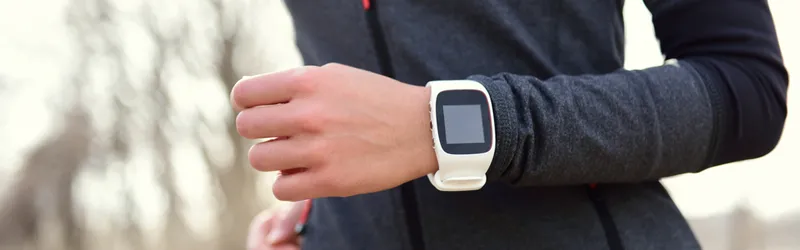 Photo of woman running wearing an Apple watch.