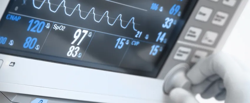 Graphic image showing a gloved hand adjusting a dial on a hospital room display screen.