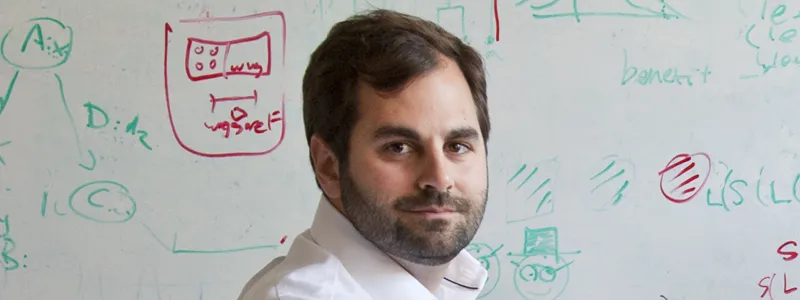Photo of Dr. Michael Frank in front of a whiteboard.