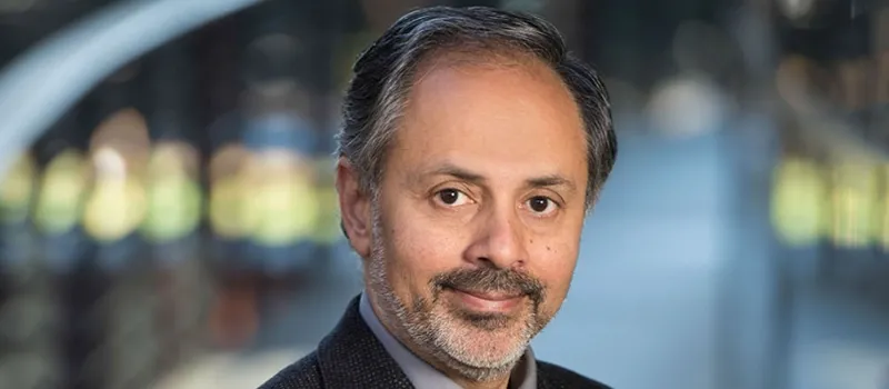 Photo of Dr. Sam Gambhir standing in middle of Clark Center building.