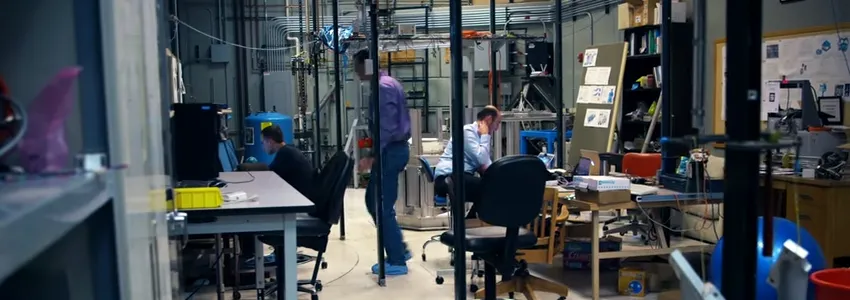 Photo of scientists working on gravitational wave research in laboratory.