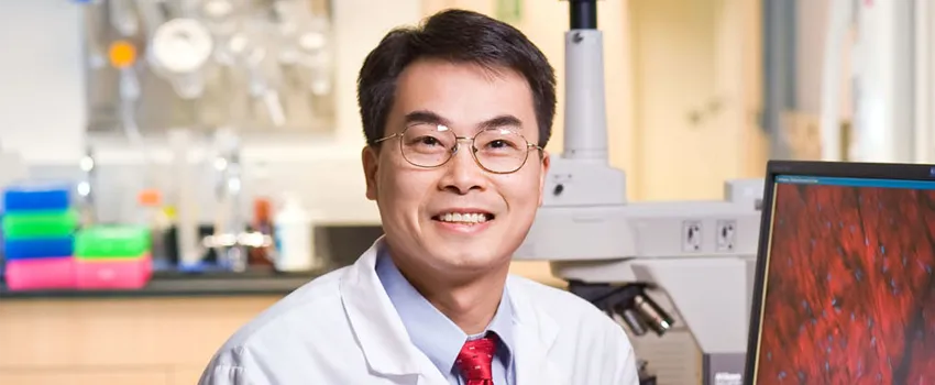 Photo of Dr. Joseph Wu, wearing white coat in laboratory space.