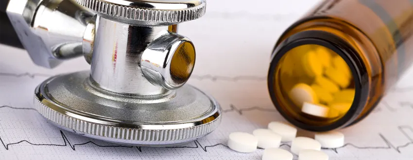 Photo of stethoscope and medication bottle.