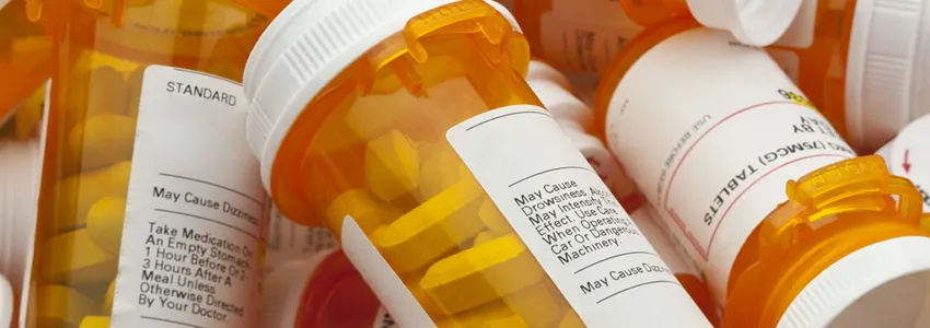 Pile of orange medication bottles.