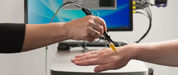 Photo by L.A. Cicero: A pen-size microscope being developed would focus a low-power laser light on a blood vessel just below the patient's skin to register dyed cancer cells.
