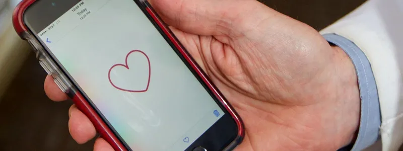 Photo of doctor holding a smartphone.