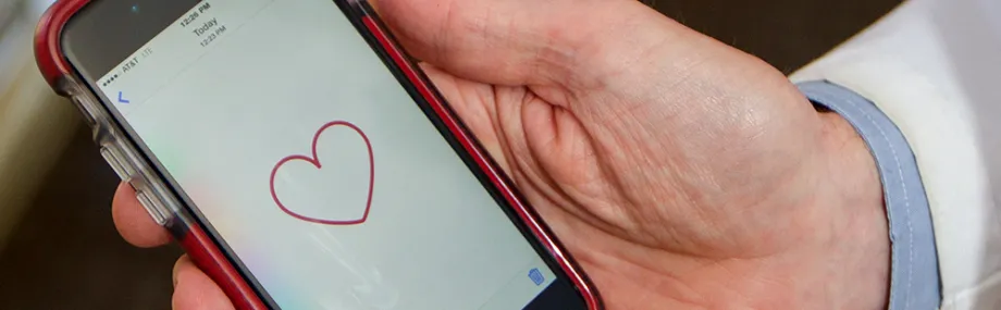Photo of MyHeart Counts app on phone screen.
