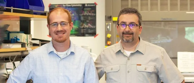 Photo of Drs. Aaron Newman and Ash Alizadeh standing in a laboratory space.