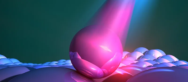 Graphic image depicting a large pink sphere colliding with a surface to represent a quantum dot.