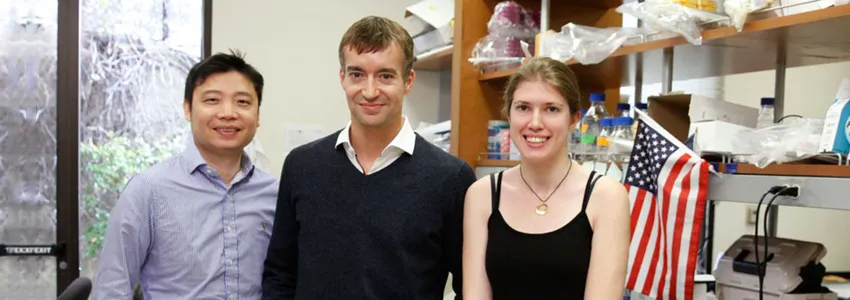 Photo of Dong Wang, Gregory Scherrer, and Elizabeth Sypek in the laboratory.