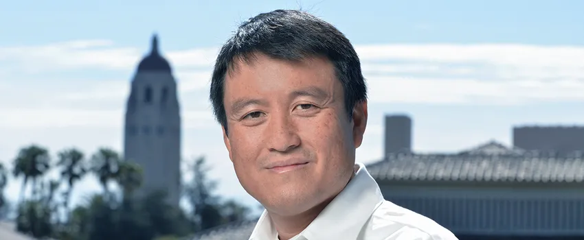 Photo of Dr. Shanhui Fan at Stanford, with Hoover Tower in the background.