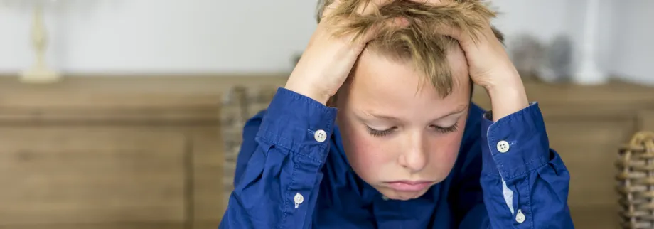 Photo of child sighing over homework.